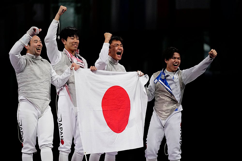 | Photo: AP/Lindsey Wasson : Japan's fencers celebrate after winning the men's team foil final
